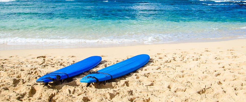 two surfboards on the beach