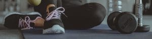 woman sitting on floor exercising